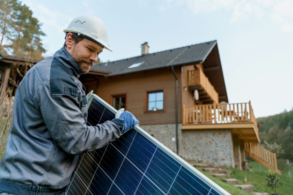 Worker installing solar panels to increase home appraisal value through sustainability upgrades