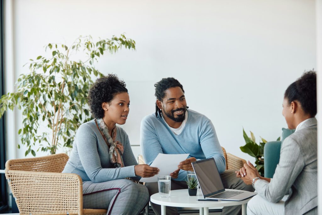 Couple discussing home appraisal questions with a professional appraiser during property evaluation